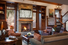 allmedia rustic room with tv above fireplace